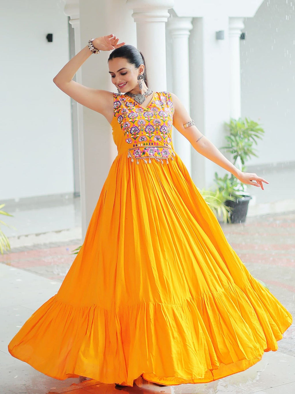 Yellow rayon sleeveless gown with kutchi gamthi embroidery and mirror work