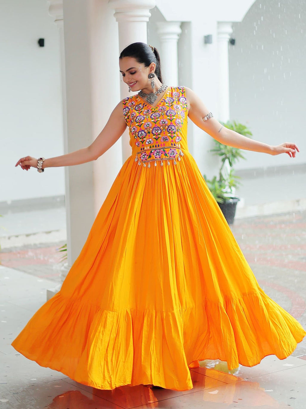 Yellow rayon sleeveless gown with kutchi gamthi embroidery and mirror work