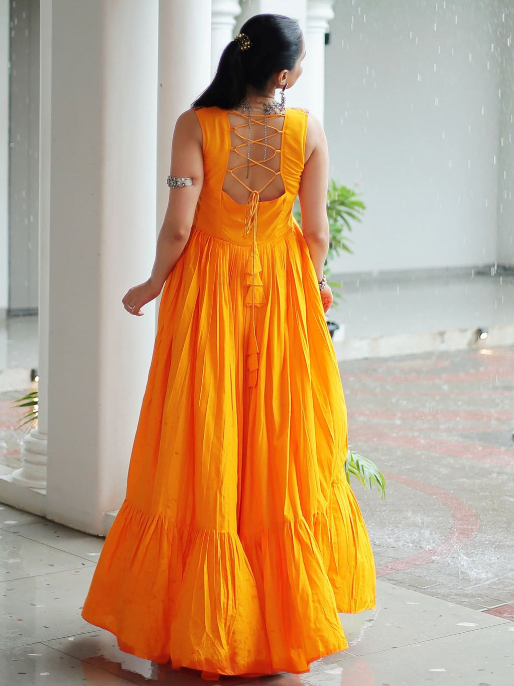 Yellow rayon sleeveless gown with kutchi gamthi embroidery and mirror work