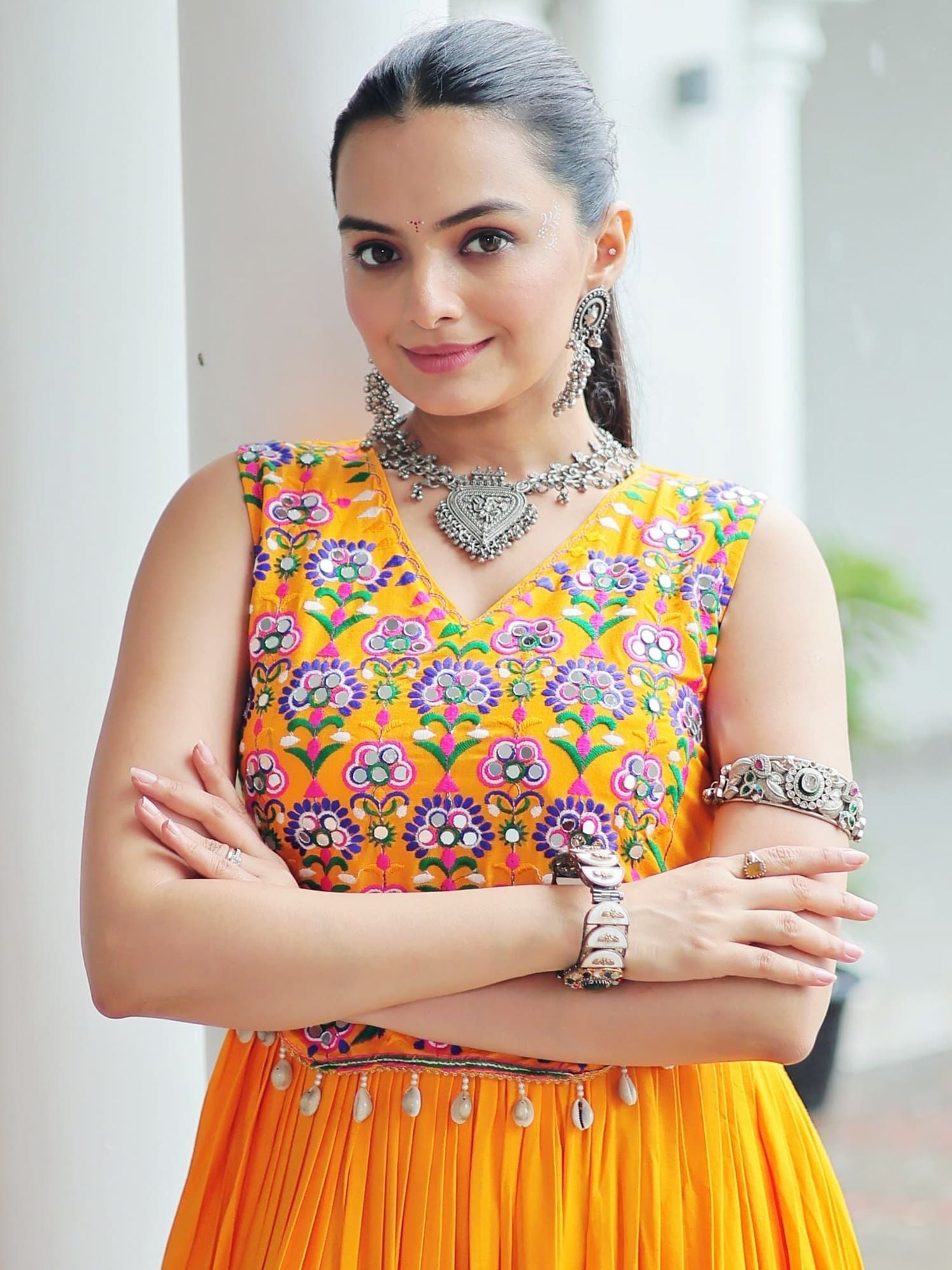Yellow rayon sleeveless gown with kutchi gamthi embroidery and mirror work
