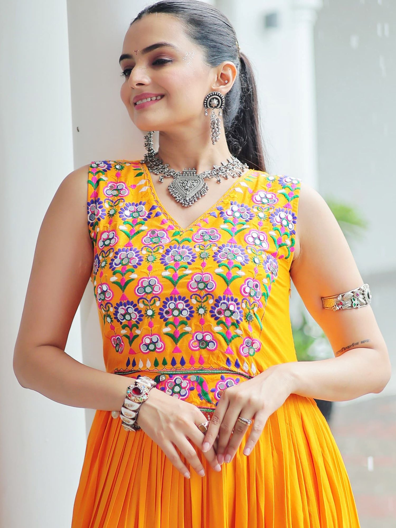 Yellow rayon sleeveless gown with kutchi gamthi embroidery and mirror work