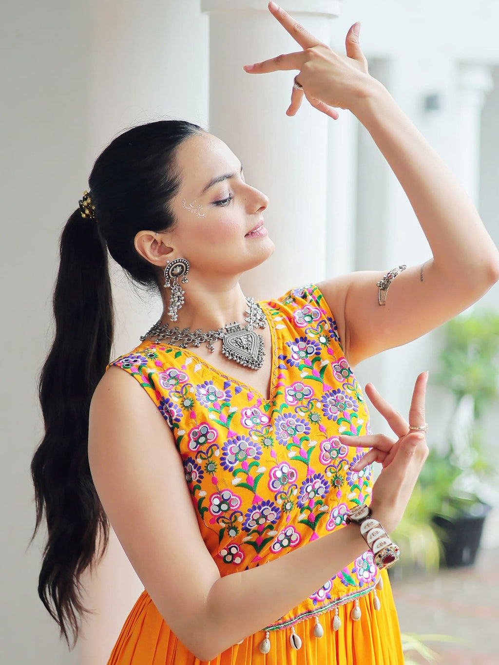 Yellow rayon sleeveless gown with kutchi gamthi embroidery and mirror work