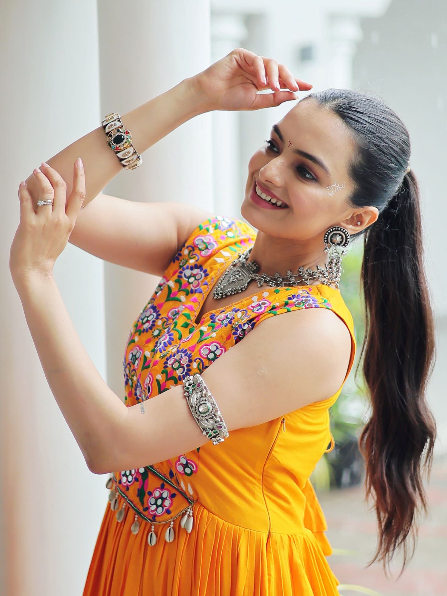Yellow rayon sleeveless gown with kutchi gamthi embroidery and mirror work