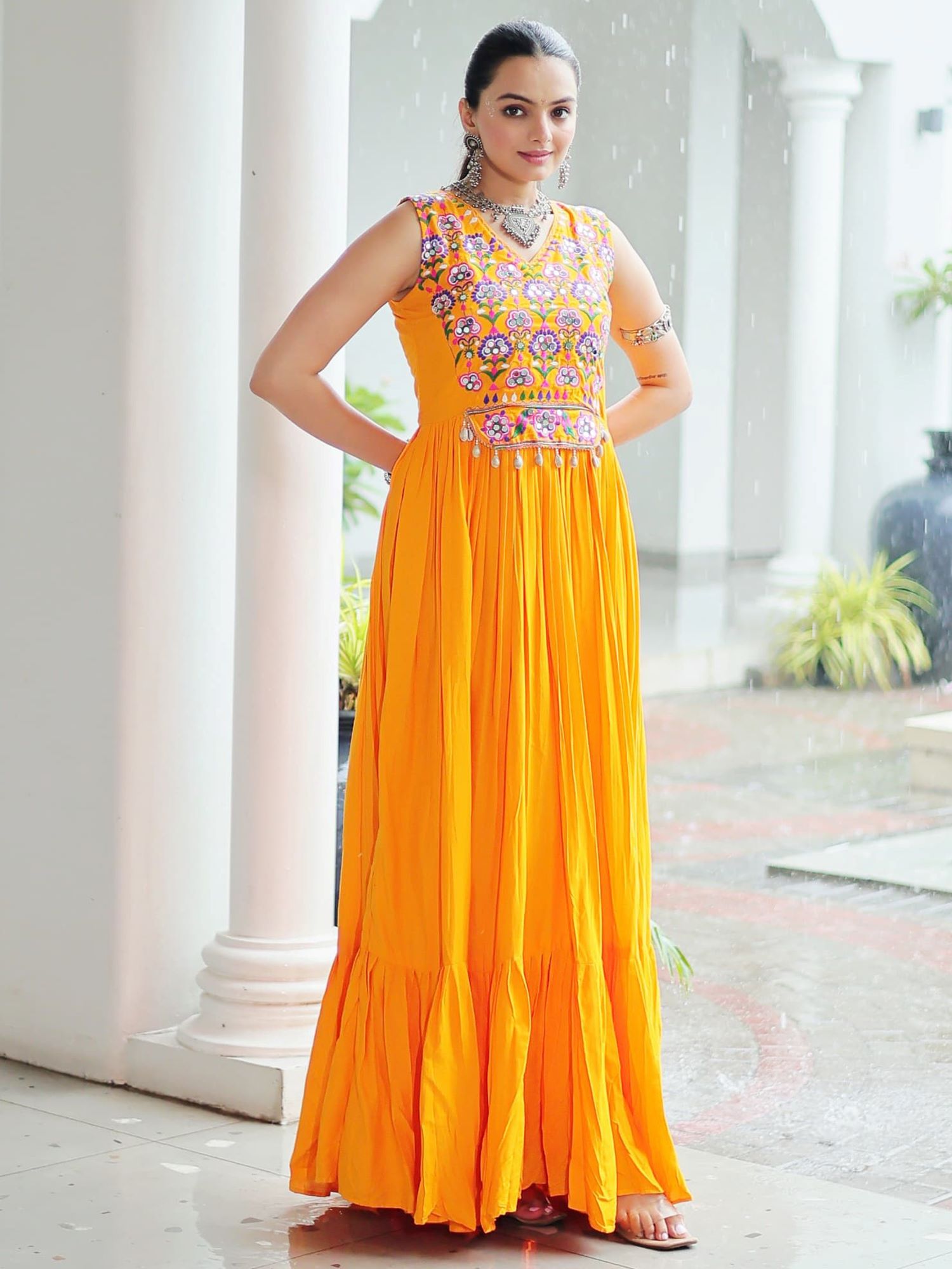 Yellow rayon sleeveless gown with kutchi gamthi embroidery and mirror work