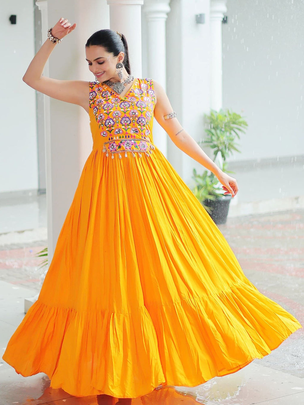 Yellow rayon sleeveless gown with kutchi gamthi embroidery and mirror work