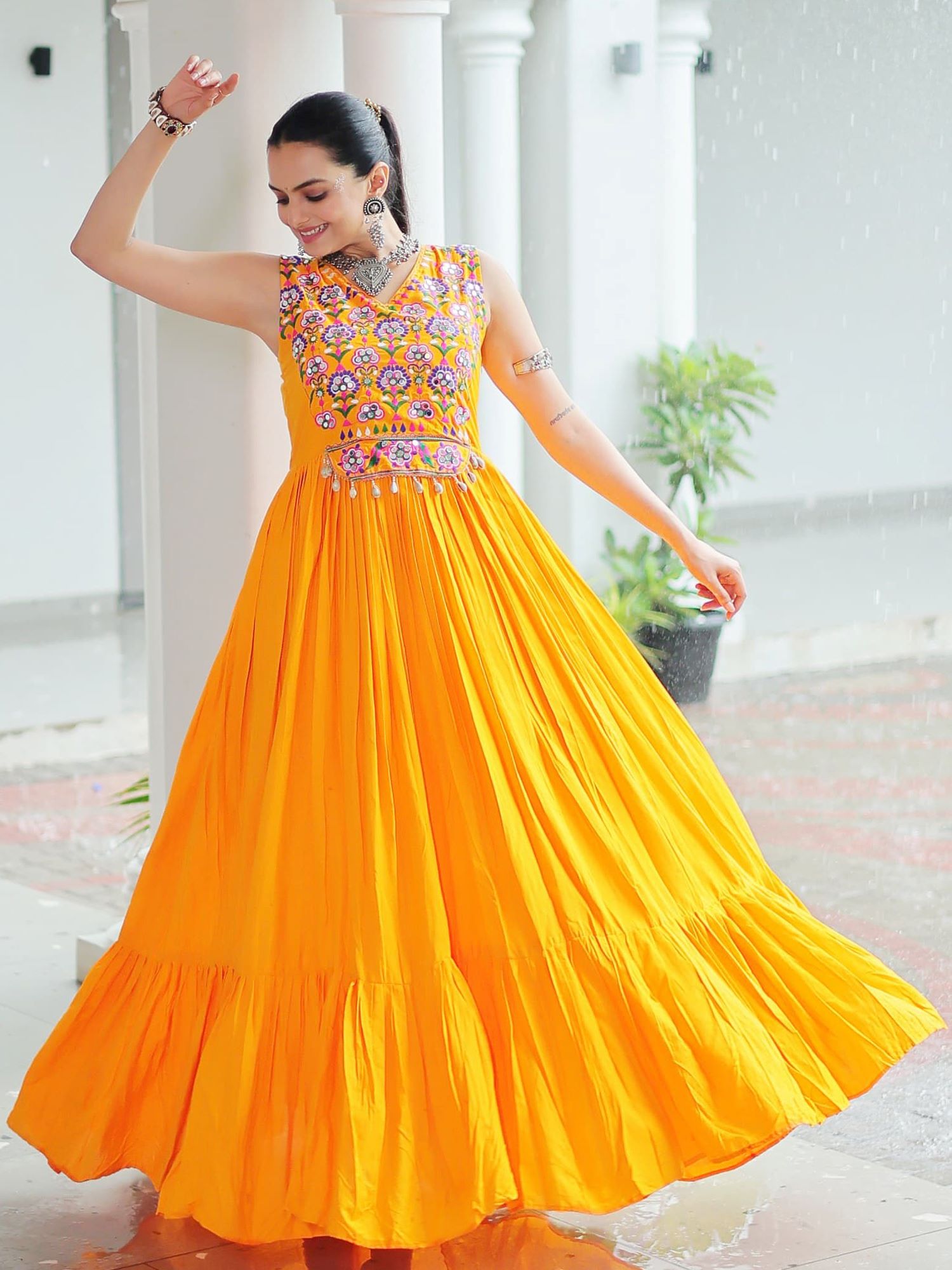 Yellow rayon sleeveless gown with kutchi gamthi embroidery and mirror work
