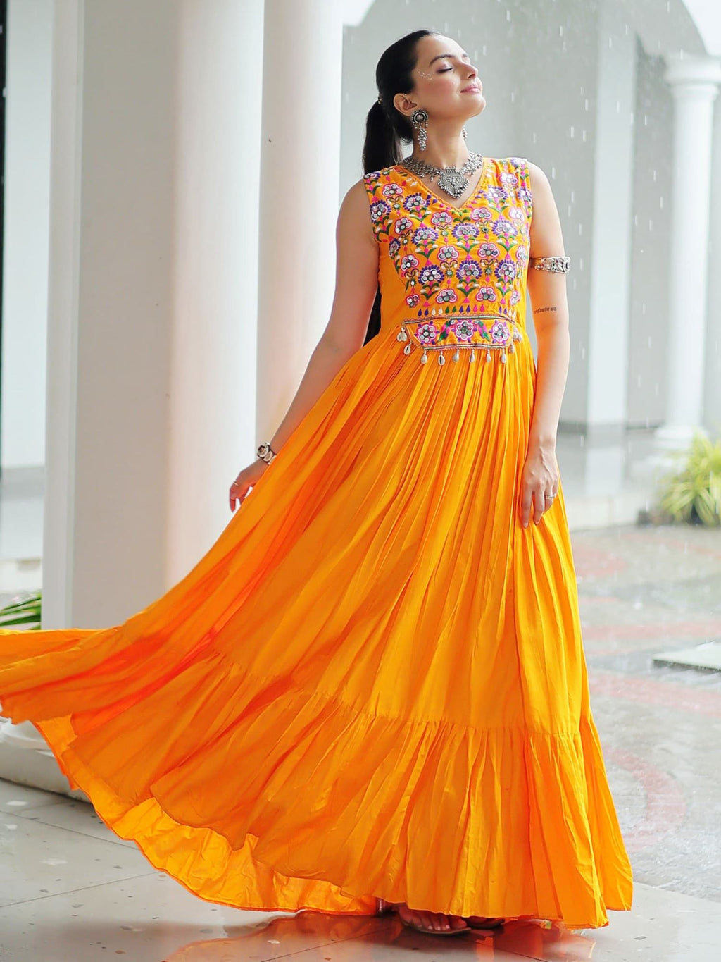 Yellow rayon sleeveless gown with kutchi gamthi embroidery and mirror work