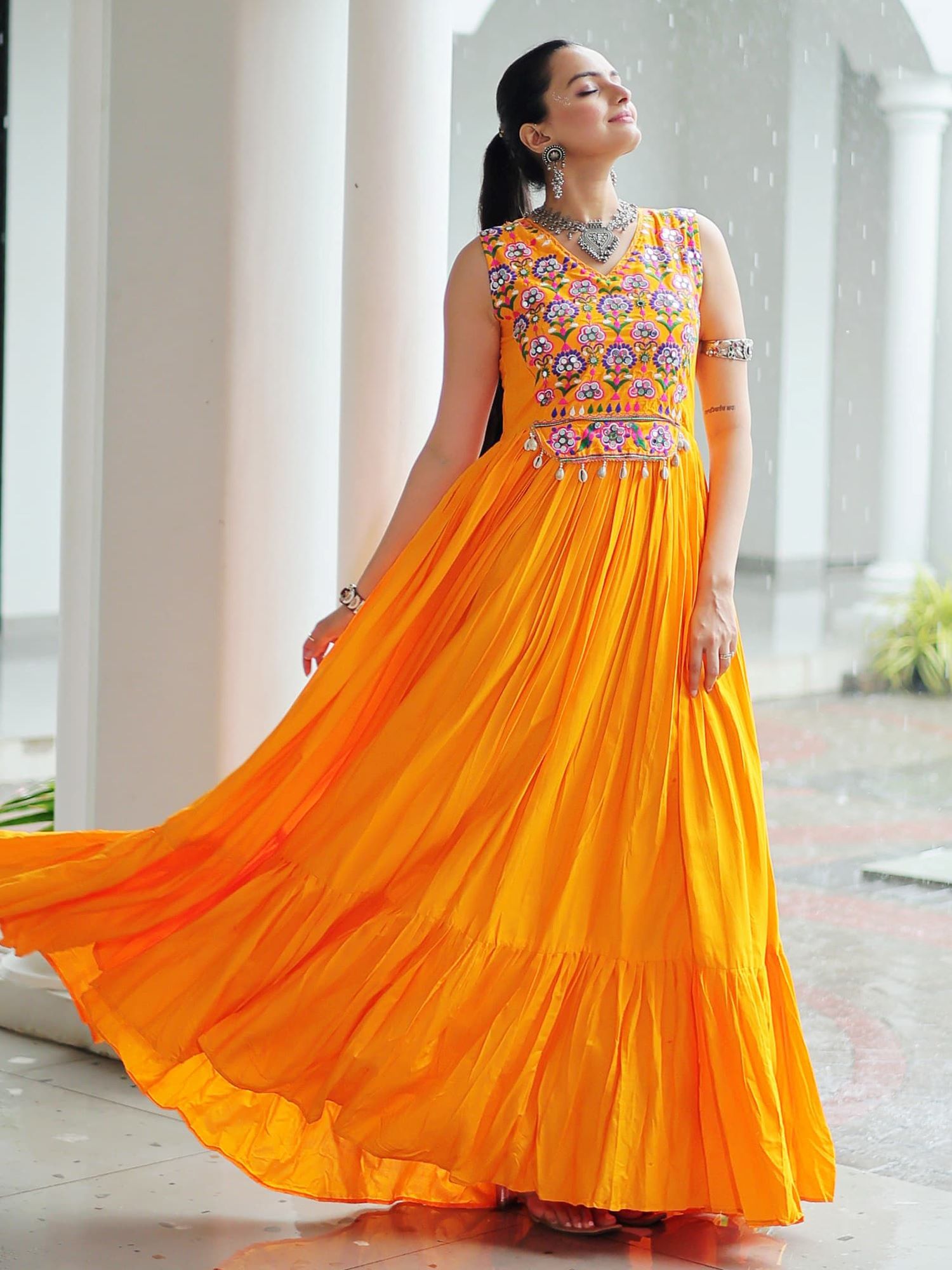Yellow rayon sleeveless gown with kutchi gamthi embroidery and mirror work