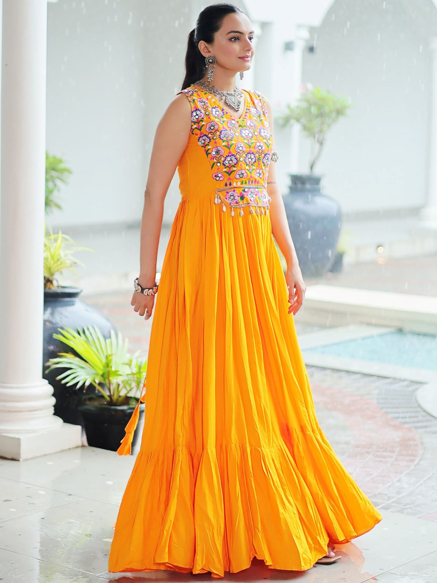 Yellow rayon sleeveless gown with kutchi gamthi embroidery and mirror work