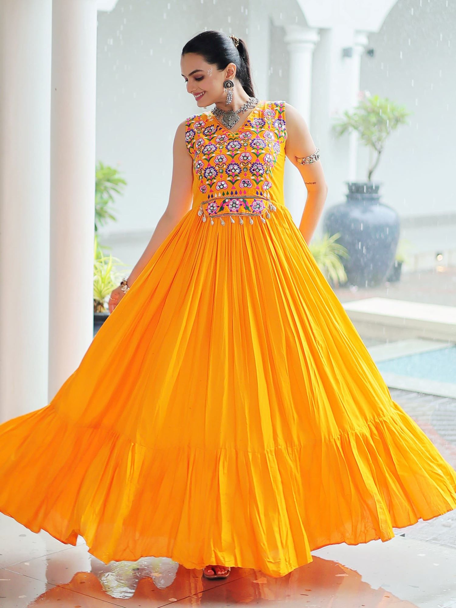 Yellow rayon sleeveless gown with kutchi gamthi embroidery and mirror work