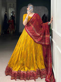 Yellow silk lehenga choli with Bandhani print and Gotta Patti lace